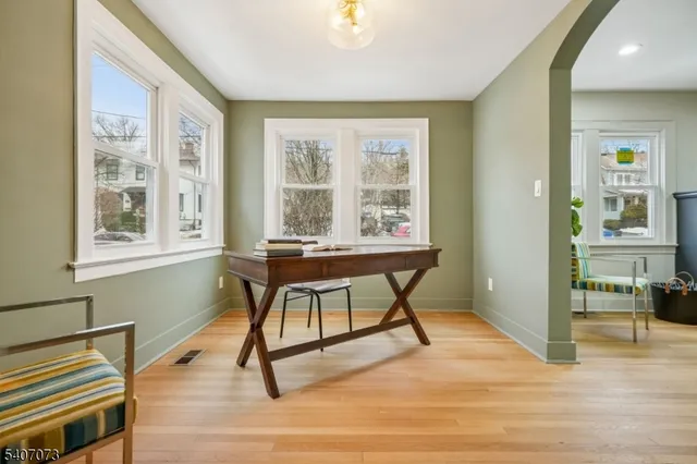 a bathroom with a granite countertop sink mirror vanity and toilet