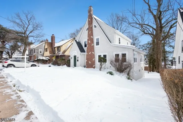 a view of a house with snow on the road