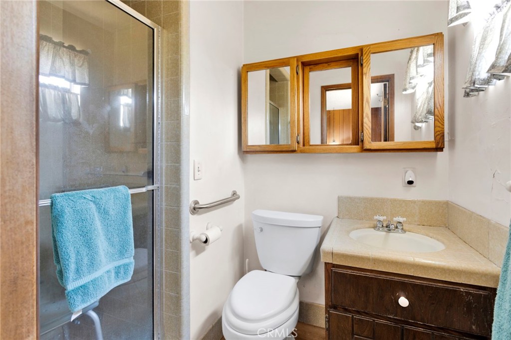 5500 Oil Well Road Phelan, CA 92371 - Photo 24 of 65 a bathroom with a sink a toilet and shower