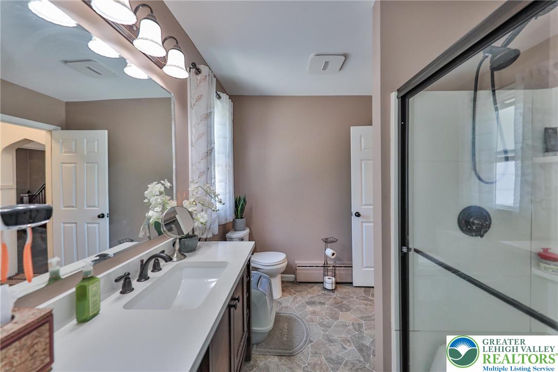 417 3rd Street Lehighton, PA 18235 - Photo 11 of 39 This primary bathroom offers a convenient walk-in shower and ample vanity space with a single sink.