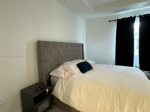 a bedroom with a bed and a chair