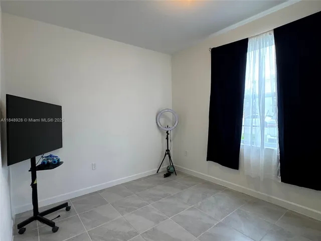 a view of a room with gym equipment and a window