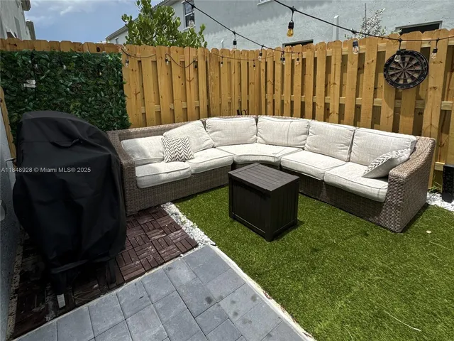 a outdoor living space with furniture and a rug