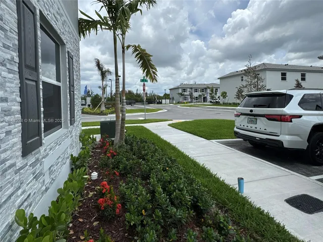 a view of a street with cars parked