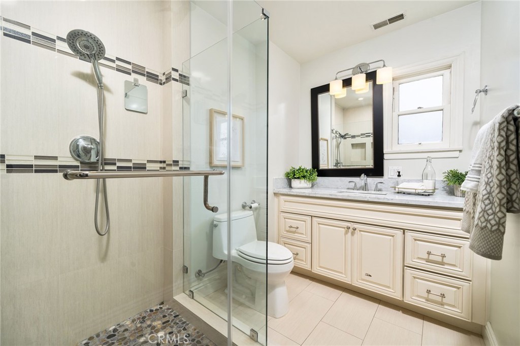 3343 San Pasqual Street Pasadena, CA 91107 - Photo 26 of 45 a bathroom with a granite countertop sink a mirror and a shower