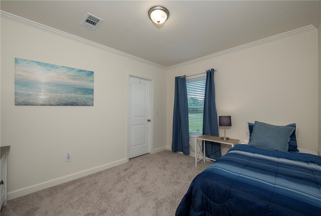 10976 Whiterock Road Bremond, TX 76629 - Photo 21 of 42 a bedroom with a bed and a large window