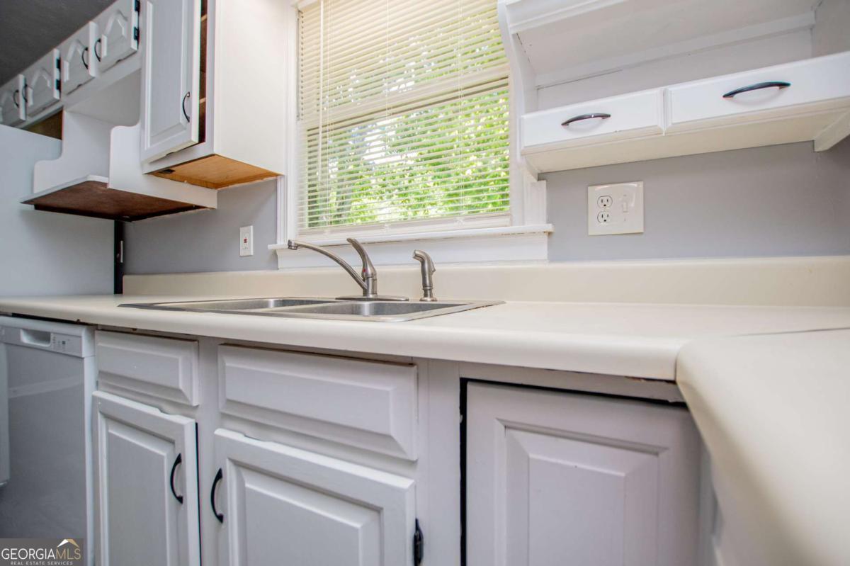 801 Bowdon Tyus Road Bowdon, GA 30108 - Photo 17 of 62 a kitchen with a sink and a window