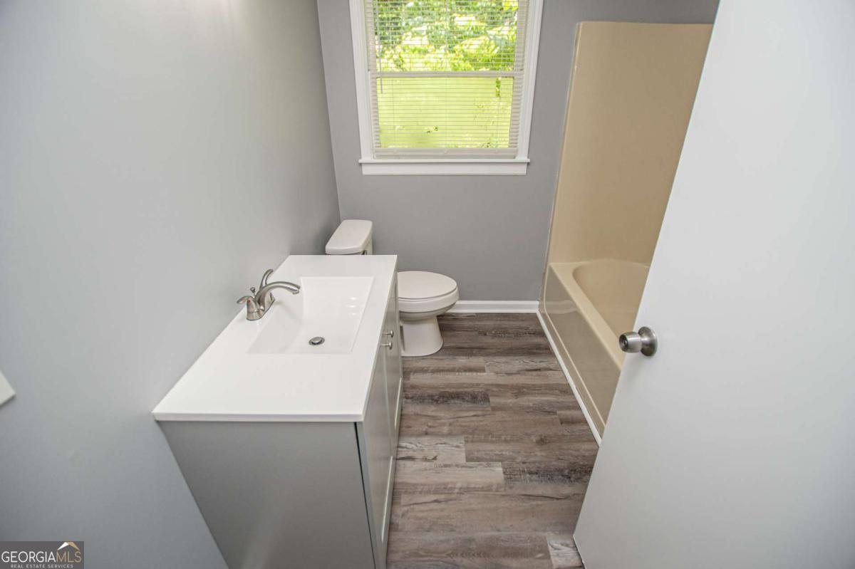 801 Bowdon Tyus Road Bowdon, GA 30108 - Photo 25 of 62 a bathroom with a sink and toilet