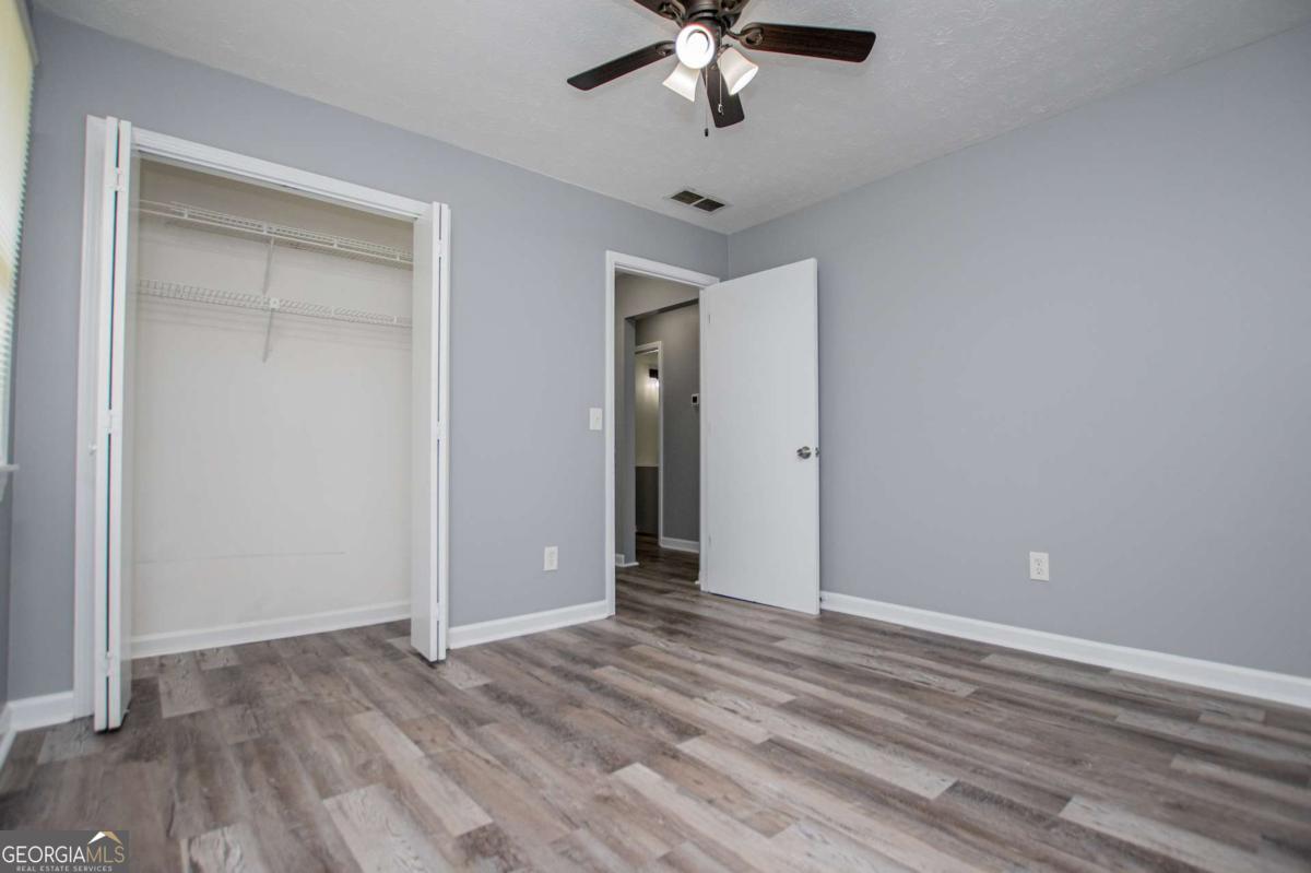 801 Bowdon Tyus Road Bowdon, GA 30108 - Photo 32 of 62 a view of an empty room with wooden floor