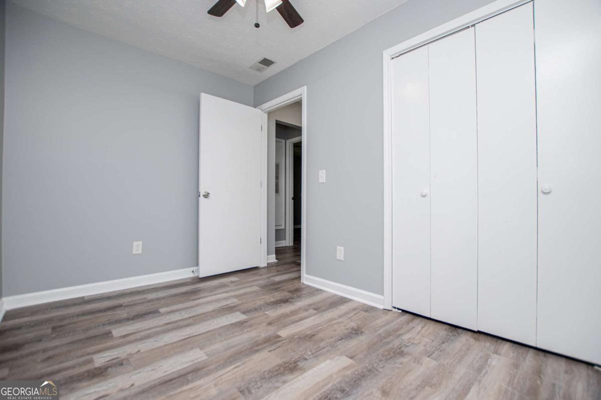 801 Bowdon Tyus Road Bowdon, GA 30108 - Photo 34 of 62 a view of an empty room with wooden floor