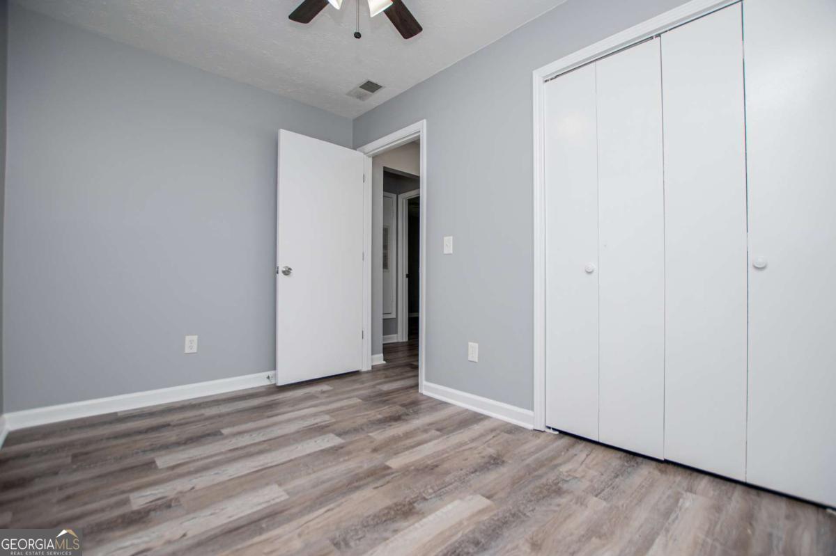 801 Bowdon Tyus Road Bowdon, GA 30108 - Photo 37 of 62 a view of an empty room with wooden floor
