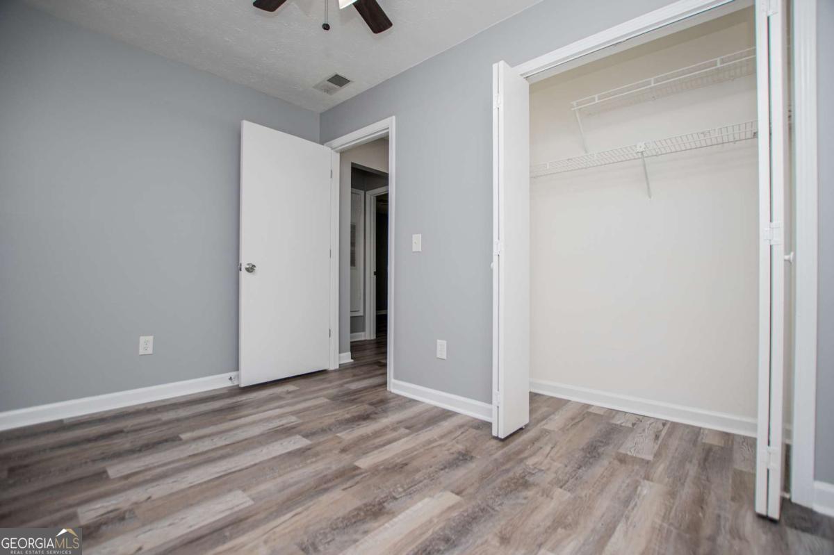 801 Bowdon Tyus Road Bowdon, GA 30108 - Photo 38 of 62 a view of an empty room with wooden floor