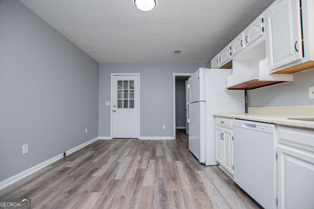 801 Bowdon Tyus Road Bowdon, GA 30108 - Photo 8 of 62 a view of a kitchen with wooden floor and electronic appliances