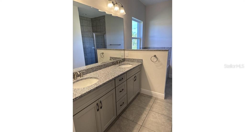 2573 Tulsa Avenue North Port, FL 34286 - Photo 7 of 11 a bathroom with a sink and a mirror