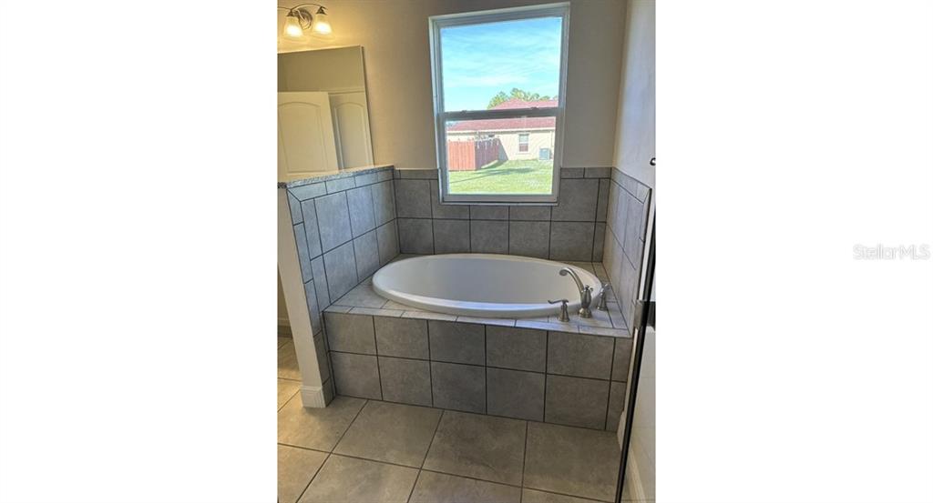 2573 Tulsa Avenue North Port, FL 34286 - Photo 8 of 11 a bathroom with a sink and a bathtub