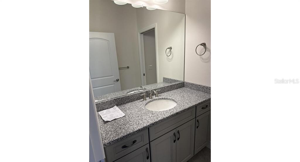 2573 Tulsa Avenue North Port, FL 34286 - Photo 10 of 11 a bathroom with a granite countertop sink and a mirror