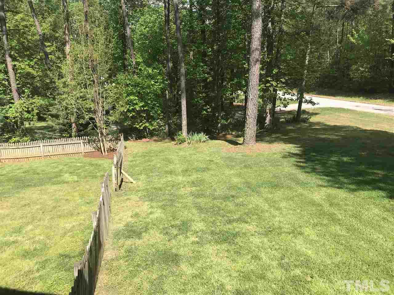 1534 Middle Ridge Drive Willow Spring, NC 27592 - Photo 18 of 23 .71 acre lot that is partially fenced. Property extends beyond the fenced area down the hill and close to the neighbor's driveway.