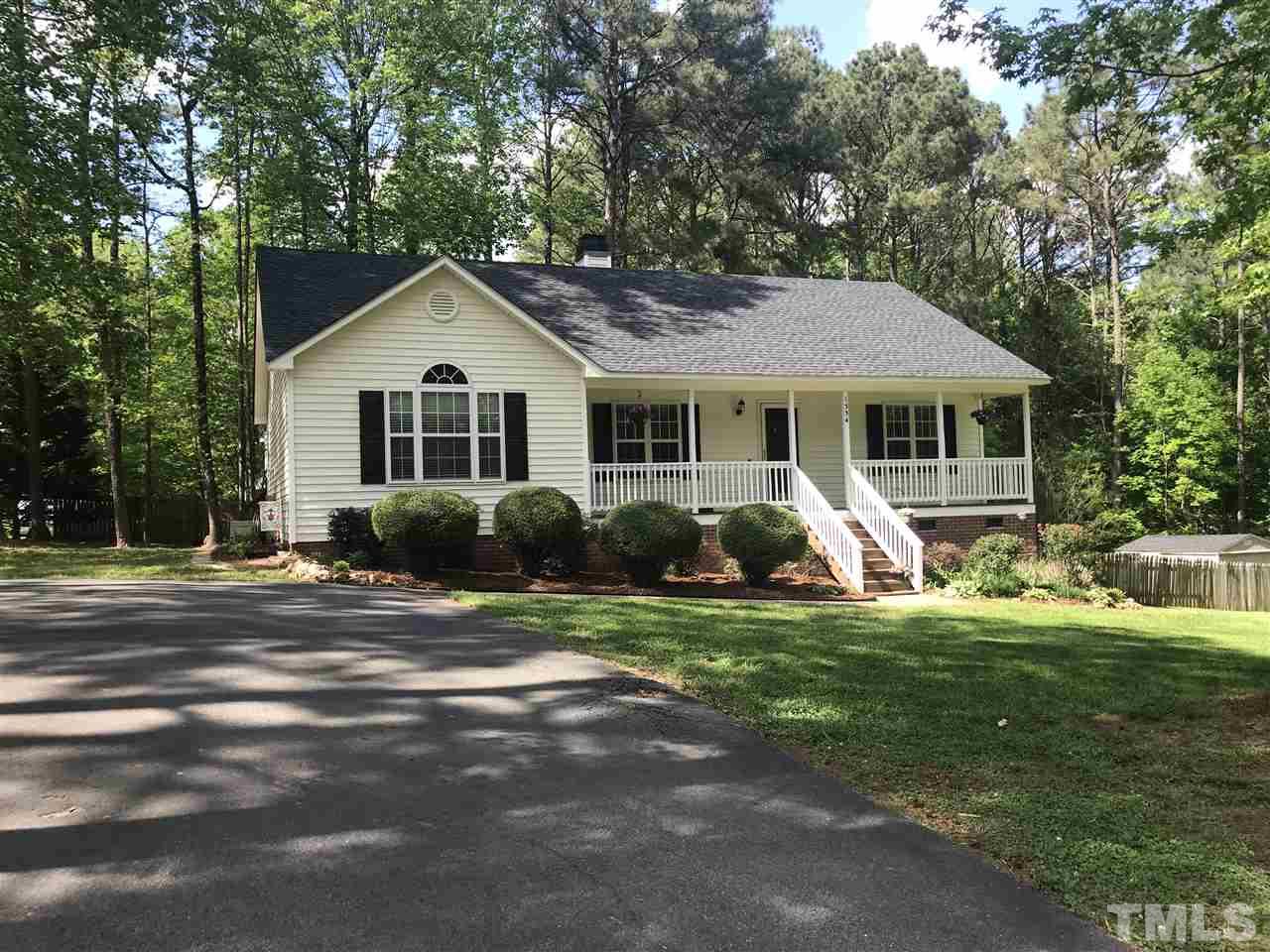 1534 Middle Ridge Drive Willow Spring, NC 27592 - Photo 19 of 23 Another view of the front of the house sitting on large yard with asphalt driveway and gravel parking pad.