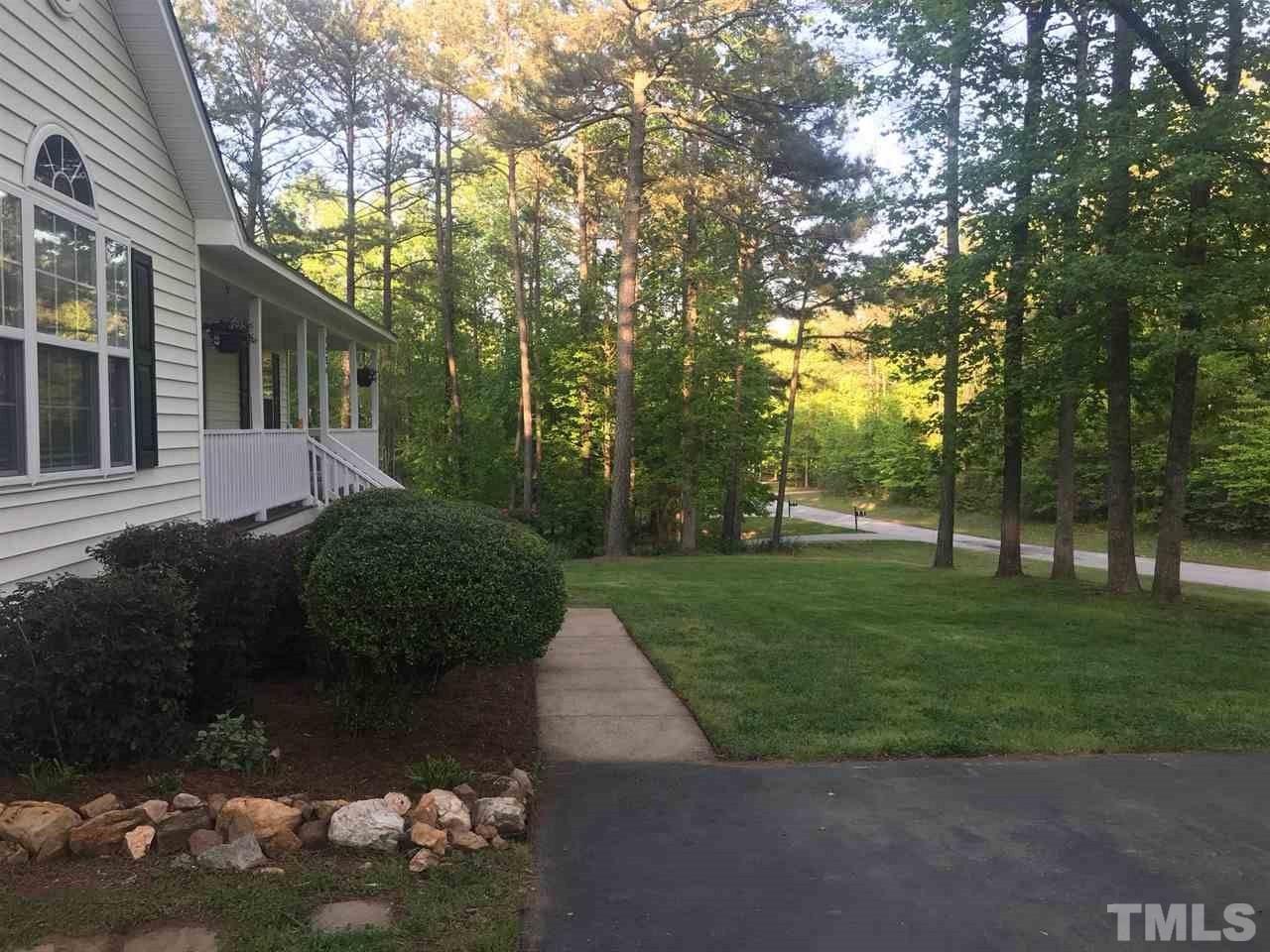 1534 Middle Ridge Drive Willow Spring, NC 27592 - Photo 22 of 23 Another view of this wonderful yard! Looking down the street to the cul-de-sac. Asphalt driveway with gravel parking pad.