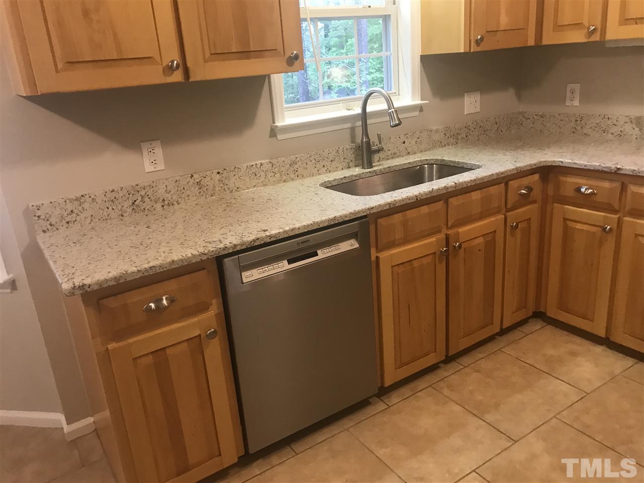 1534 Middle Ridge Drive Willow Spring, NC 27592 - Photo 6 of 23 View of kitchen showing new granite countertops with under mount stainless farmhouse sink and showing Bosch stainless dishwasher.