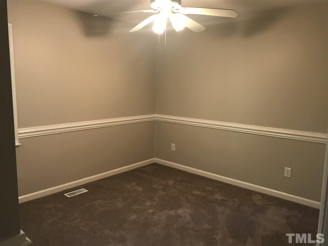 1534 Middle Ridge Drive Willow Spring, NC 27592 - Photo 7 of 23 Cute second bedroom with wainscoting beadboard, new carpet and ceiling fan with light.