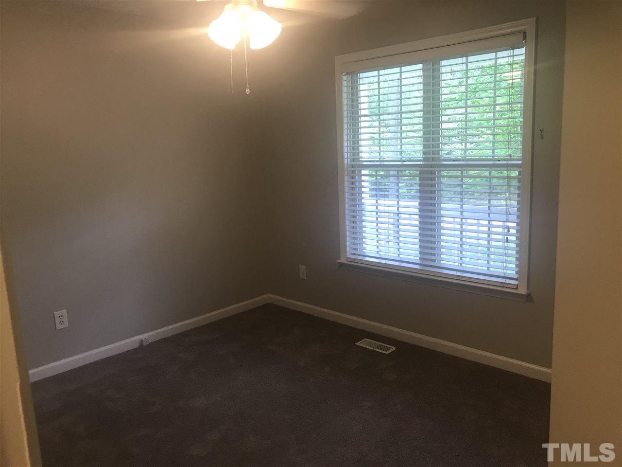 1534 Middle Ridge Drive Willow Spring, NC 27592 - Photo 8 of 23 Bedroom 3 features new carpet and ceiling fan with light.