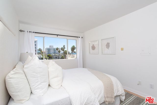 a large white bed in a white room