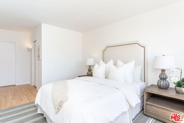 a bedroom with a bed and lamp