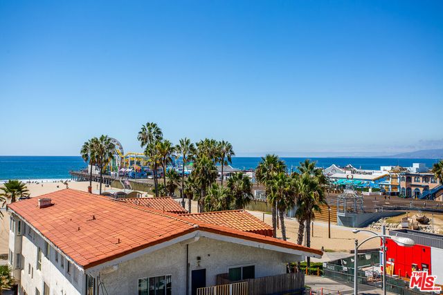 a terrace with a table and chairs and potted plants