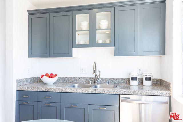 a kitchen with granite countertop cabinets sink and window