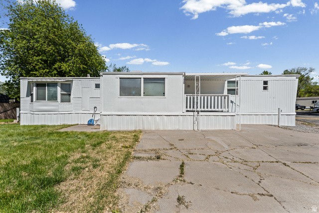 24 Grover Street Layton, UT 84041 - Photo 9 of 21 White paneled exterior with a covered porch