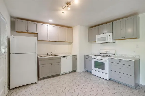 a kitchen with cabinets appliances and a counter space