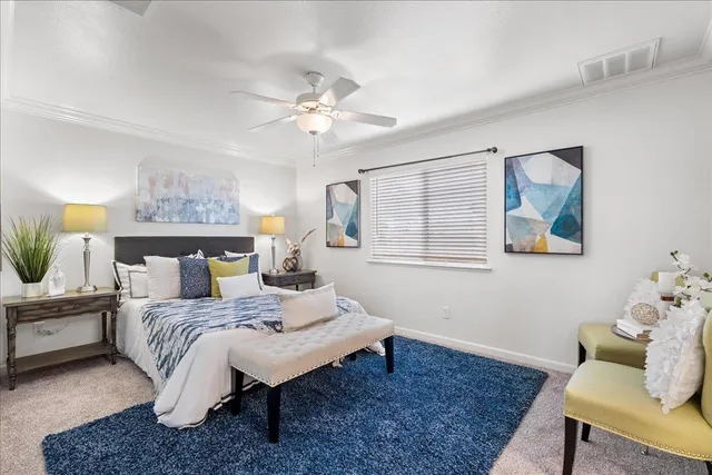 a bedroom with a bed and a chandelier