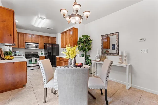 a dining room with furniture a chandelier and window