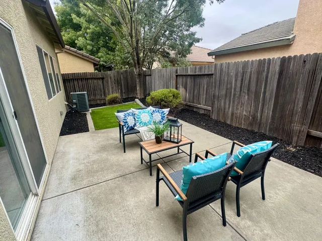 a view of a chairs with a table in the patio