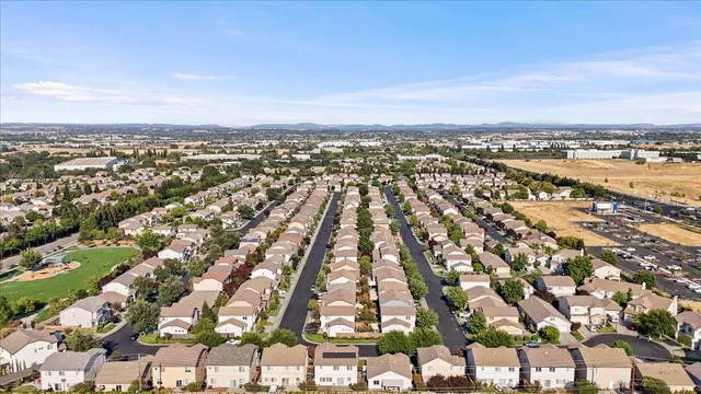 an aerial view of residential building with yard