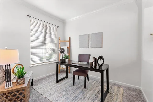 a view of a workspace room with furniture and wooden floor