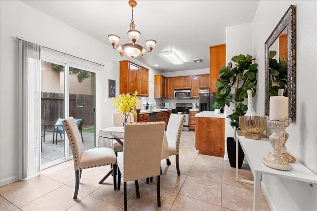 a dining room filled with furniture and a chandelier