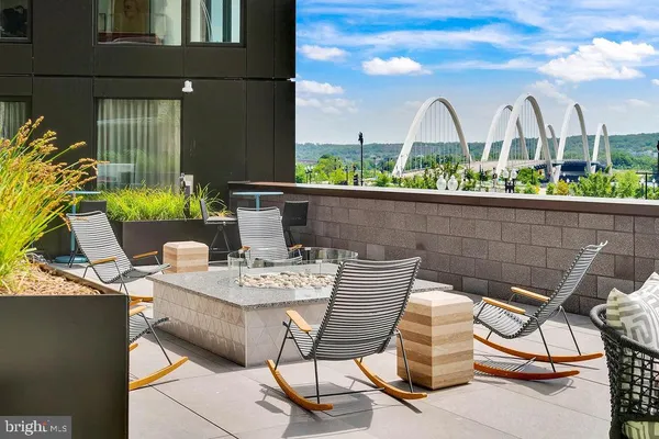 a view of a patio with couches table and chairs and potted plants
