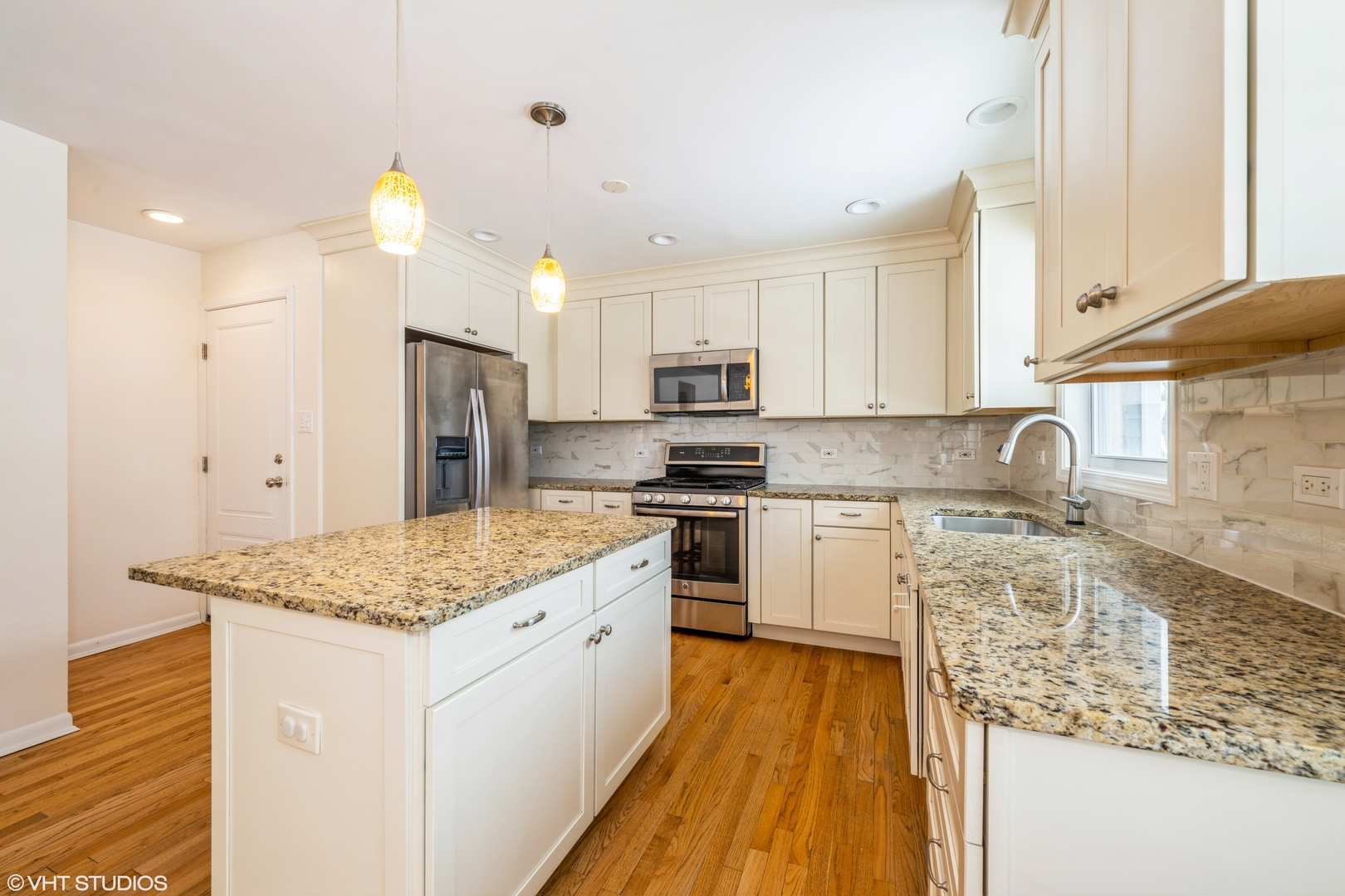2027 Dundee Road Northbrook, IL 60062 - Photo 3 of 9 a kitchen with stainless steel appliances granite countertop a sink stove and refrigerator