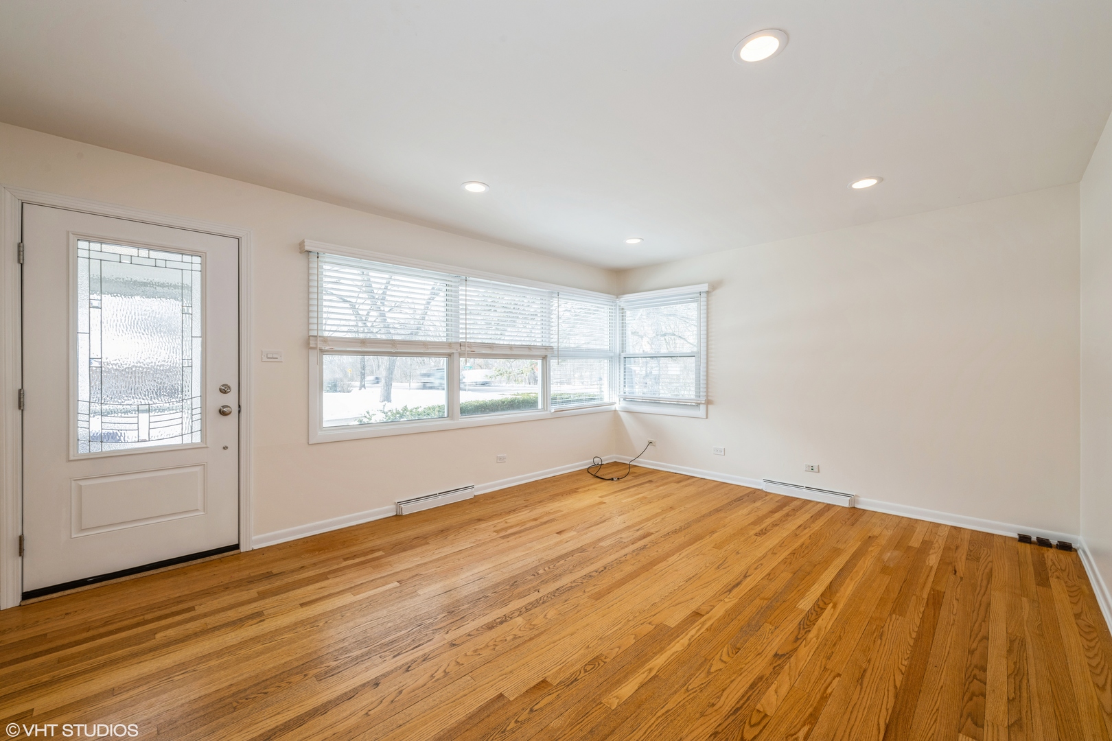 2027 Dundee Road Northbrook, IL 60062 - Photo 4 of 9 a view of empty room with wooden floor and fan
