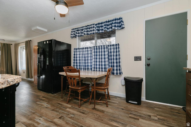 1105 Litz Road Preston, ID 83263 - Photo 9 of 24 Dining space with dark wood-style flooring, crown molding, and a ceiling fan