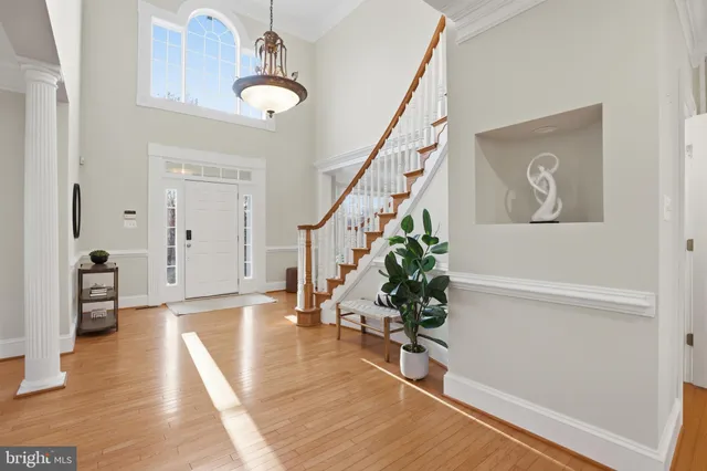 a view of an entryway with wooden floor and stairs
