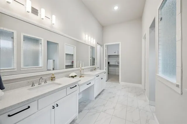 a spacious bathroom with a double vanity sink mirror double and shower
