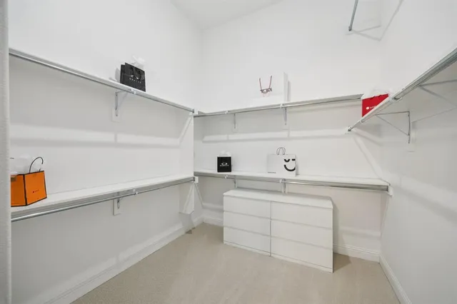 a kitchen with white cabinets and sink