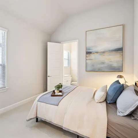 a bedroom with a bed and a large window