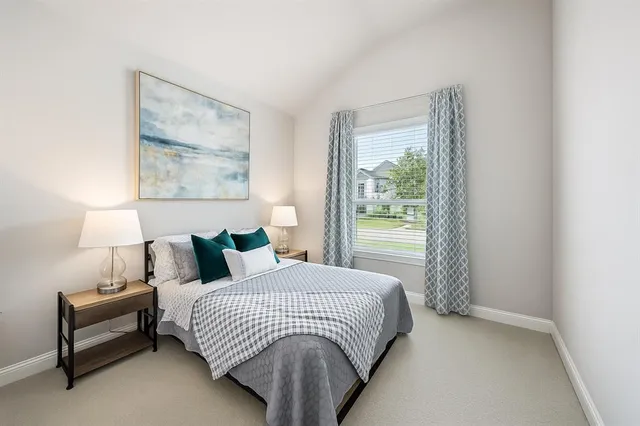 a bedroom with a bed and a night stand