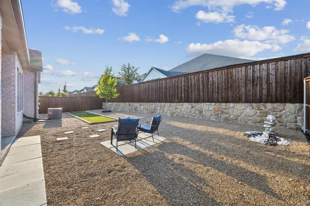 a view of a backyard with swimming pool and furniture