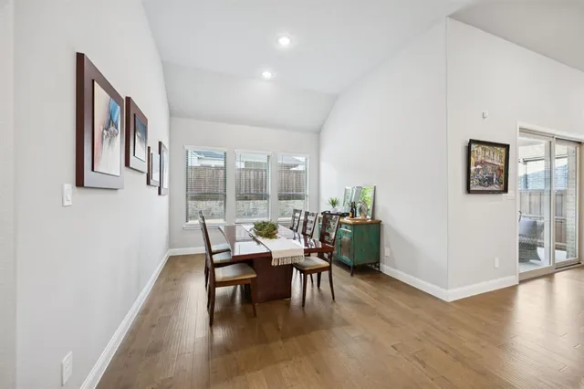 a dining room with furniture and wooden floor