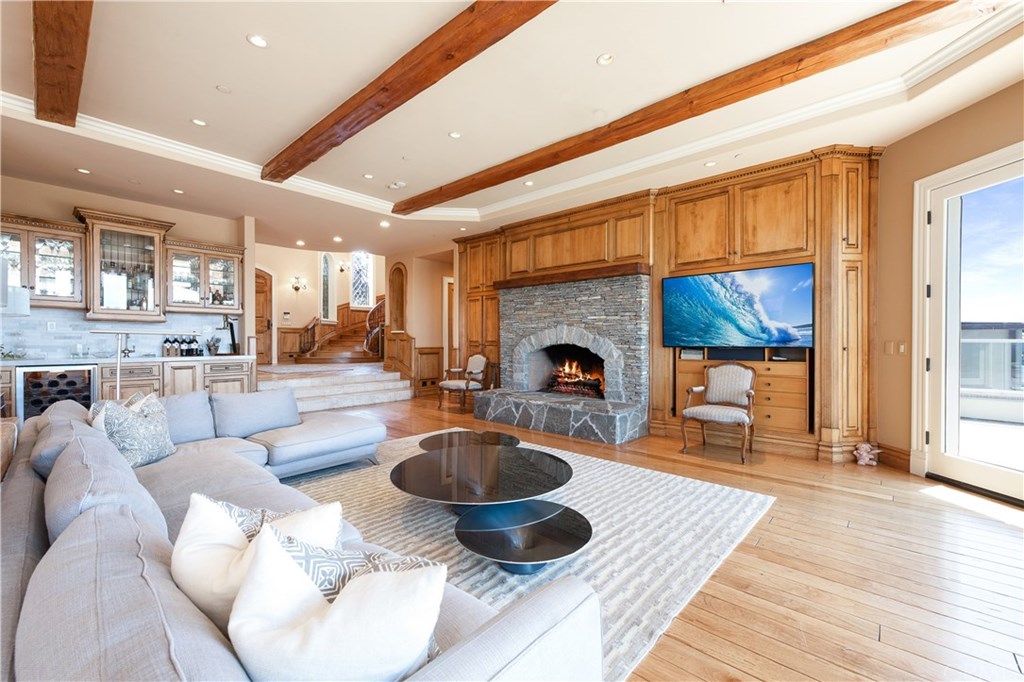 911 Kings Road Newport Beach, CA 92663 - Photo 11 of 47 a living room with furniture a fireplace and a table